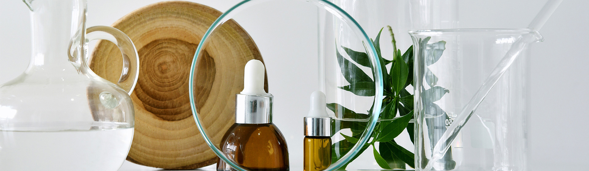 faqs Image of glass laboratory jar, a glass water jug and two cosmetic jars with droppers